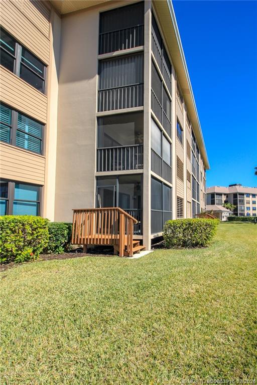 4490 Northeast Sandpebble Trace, Unit 105 Stuart, FL 34996 - Photo 24 of 38 a view of pool with yard