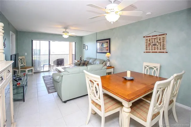 a view of a dining room with furniture and a large window