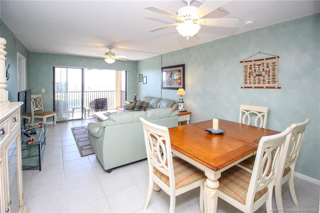 4490 Northeast Sandpebble Trace, Unit 105 Stuart, FL 34996 - Photo 4 of 38 a view of a dining room with furniture and a large window