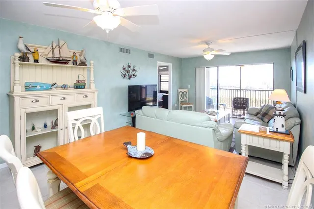 a view of a dining room with furniture and a chandelier