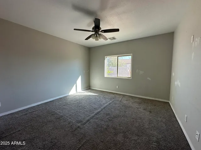 a view of a livingroom with a ceiling fan and window