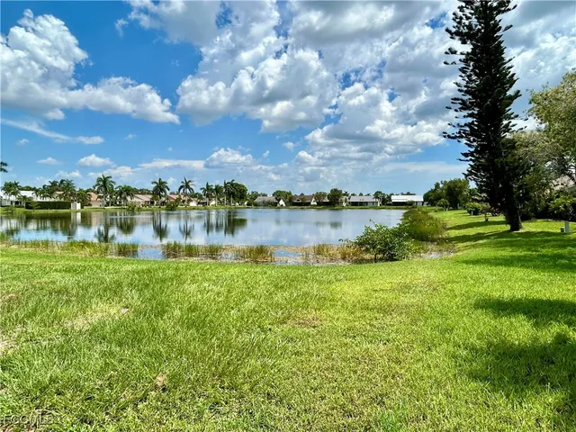 a view of a lake with houses in the back