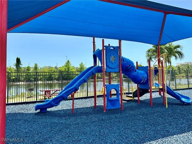 a view of swimming pool with a table and chairs