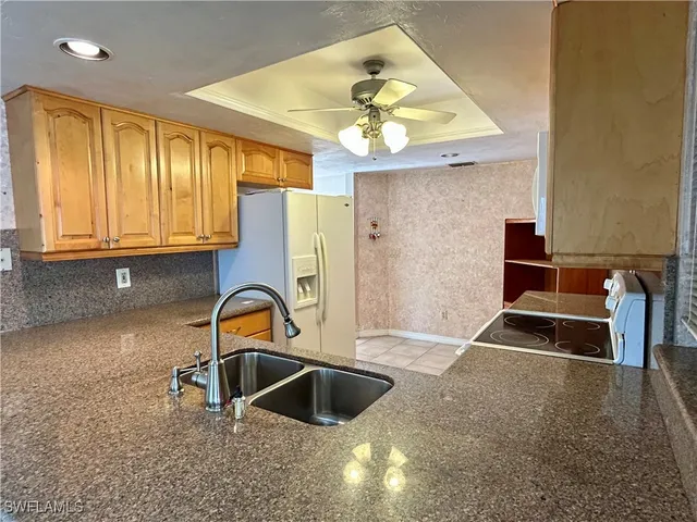 a kitchen with a sink a stove and a microwave