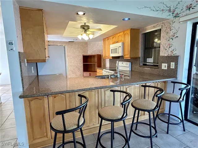 a dining room filled chandelier and wooden floor