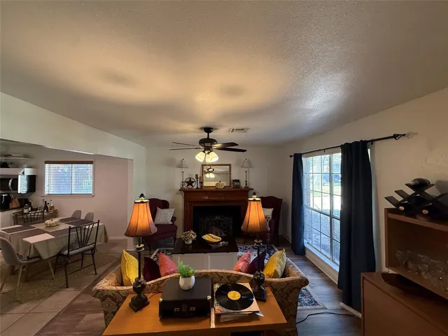 a living room with furniture a window and a flat screen tv