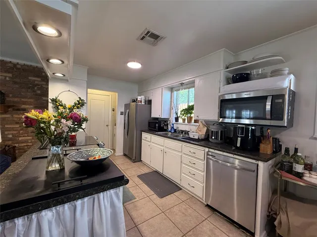 a kitchen with sink stove and refrigerator