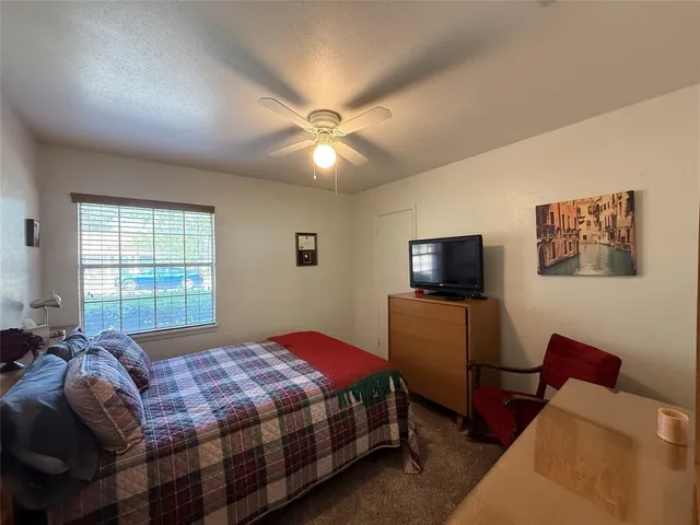 a bedroom with a bed and a television