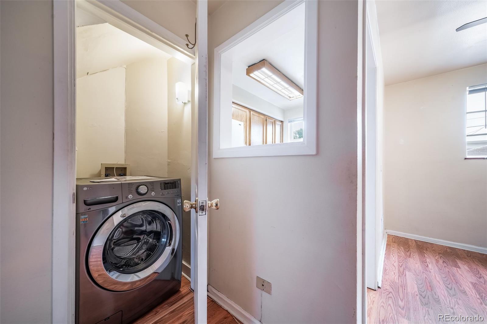 1456 Galena Street Aurora, CO 80010 - Photo 13 of 34 a view of a hallway with washer and dryer