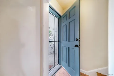 a view of a hallway with wooden floor and entryway