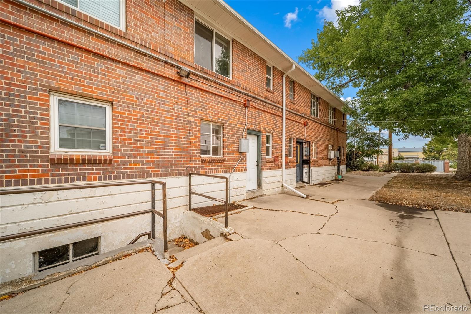 1456 Galena Street Aurora, CO 80010 - Photo 23 of 34 a view of a blue house with many windows