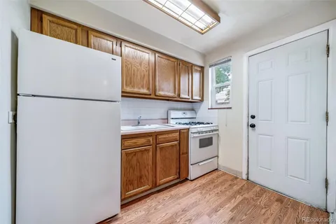 a kitchen with stainless steel appliances granite countertop a refrigerator sink and cabinets
