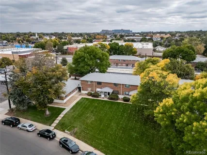 aerial view of a house with a garden and lake view