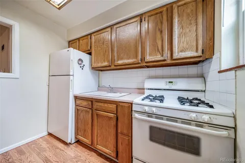 a kitchen with stainless steel appliances white cabinets and a stove top oven