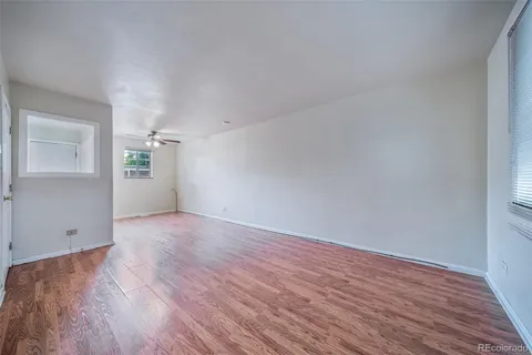 a view of empty room with wooden floor
