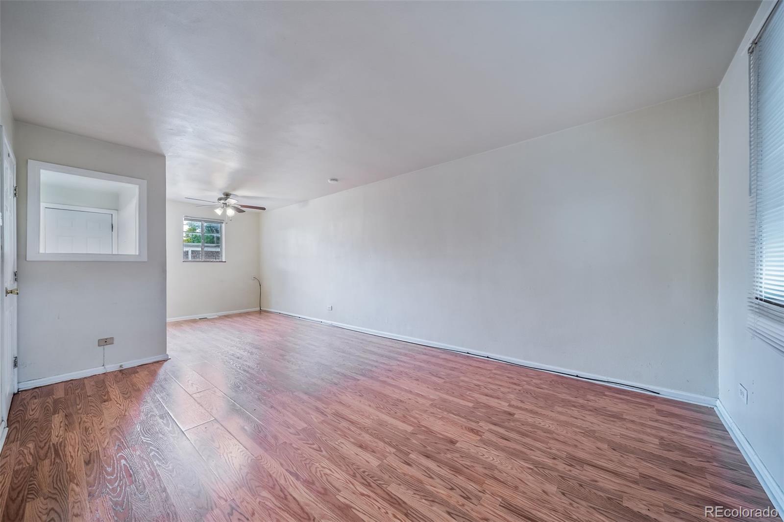 1456 Galena Street Aurora, CO 80010 - Photo 8 of 34 a view of empty room with wooden floor