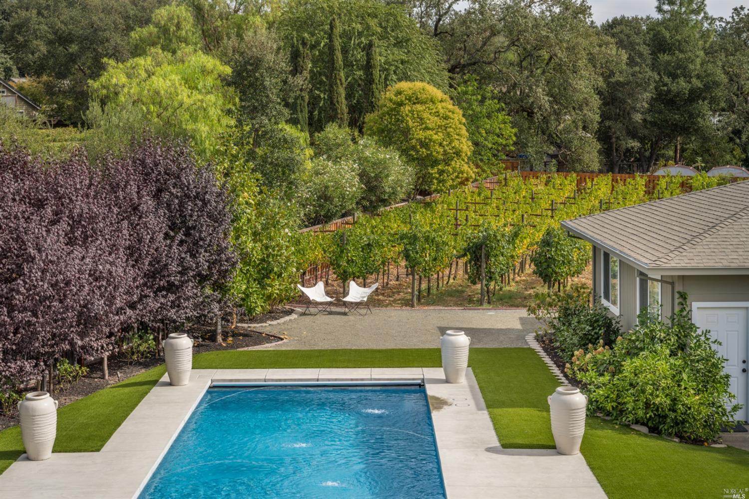 a view of a swimming pool with an outdoor seating and yard