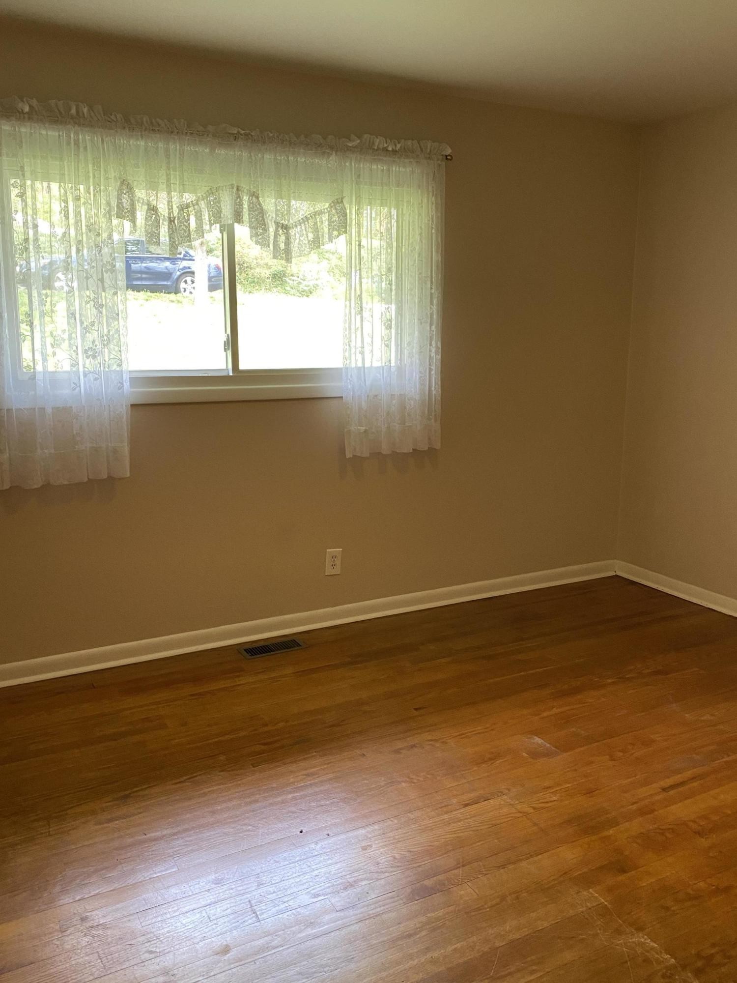 107 Morgan Road Oak Ridge, TN 37830 - Photo 17 of 24 a view of empty room with wooden floor and fan