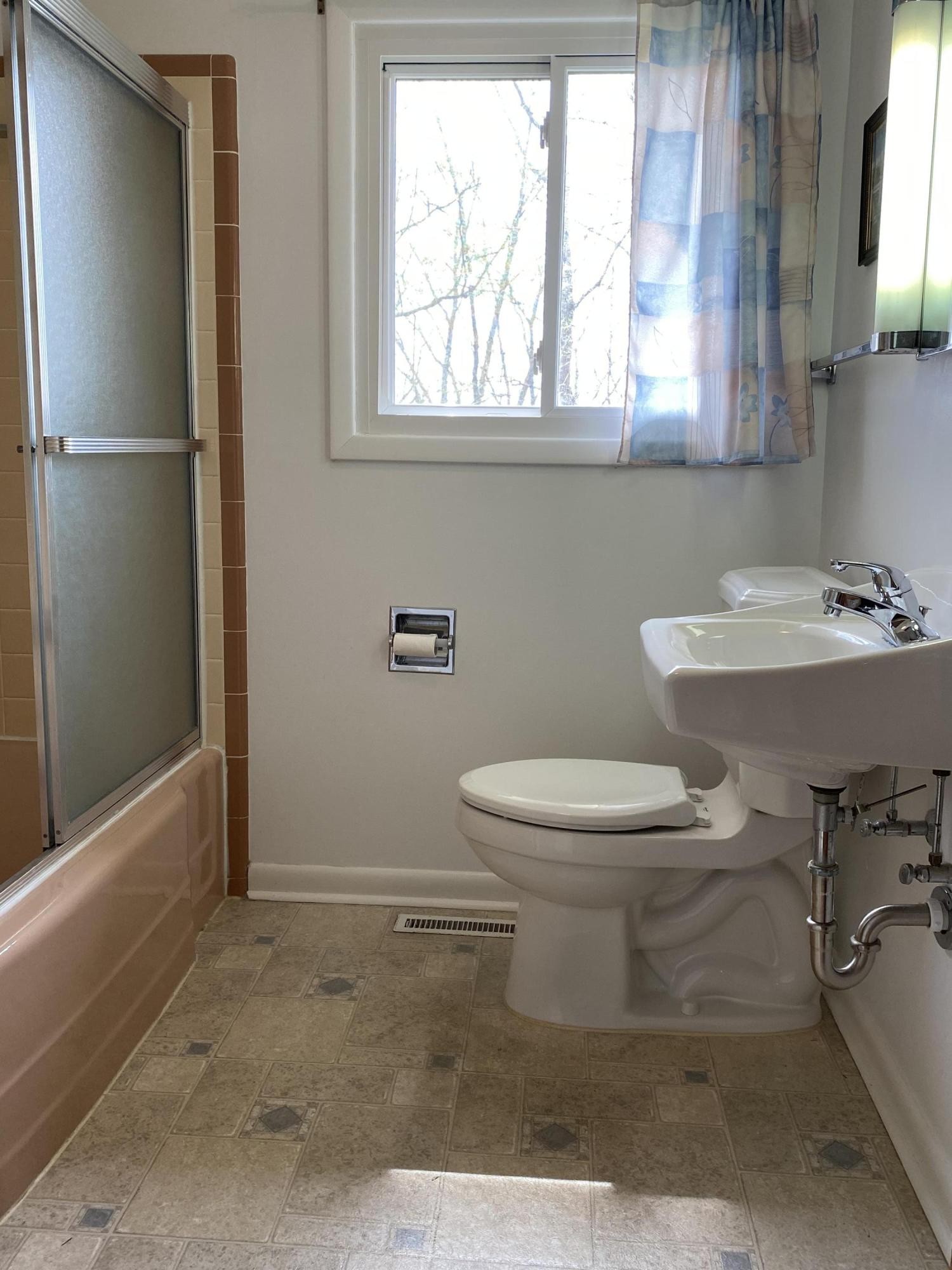 107 Morgan Road Oak Ridge, TN 37830 - Photo 18 of 24 a white toilet sitting next to a bathroom sink