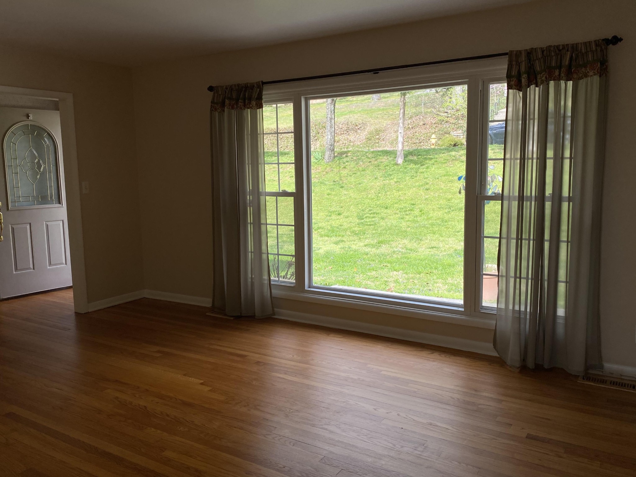 107 Morgan Road Oak Ridge, TN 37830 - Photo 3 of 24 a view of an empty room with wooden floor and a window