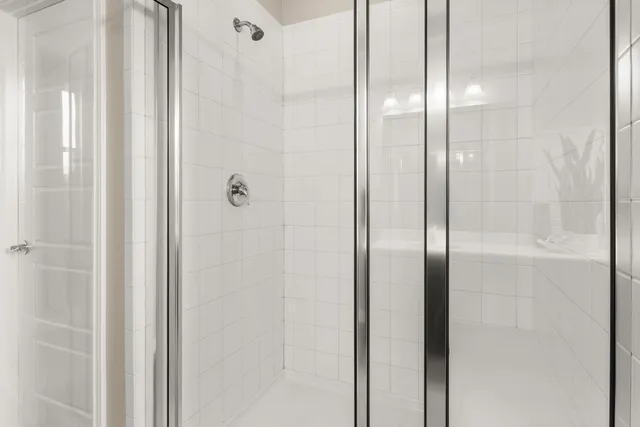 a bathroom with a glass shower door