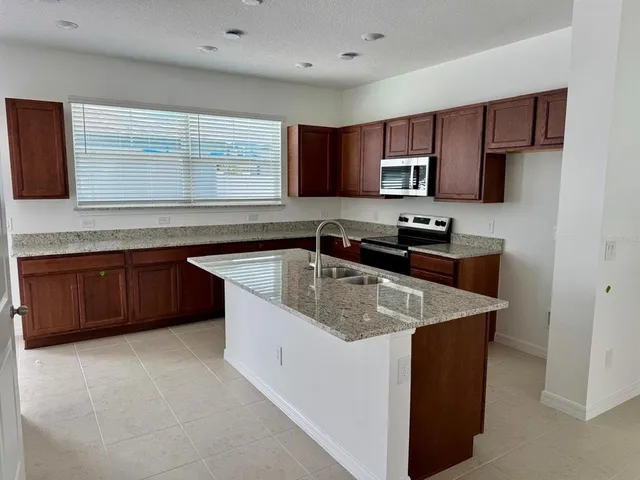a kitchen that has a sink and a stove in it