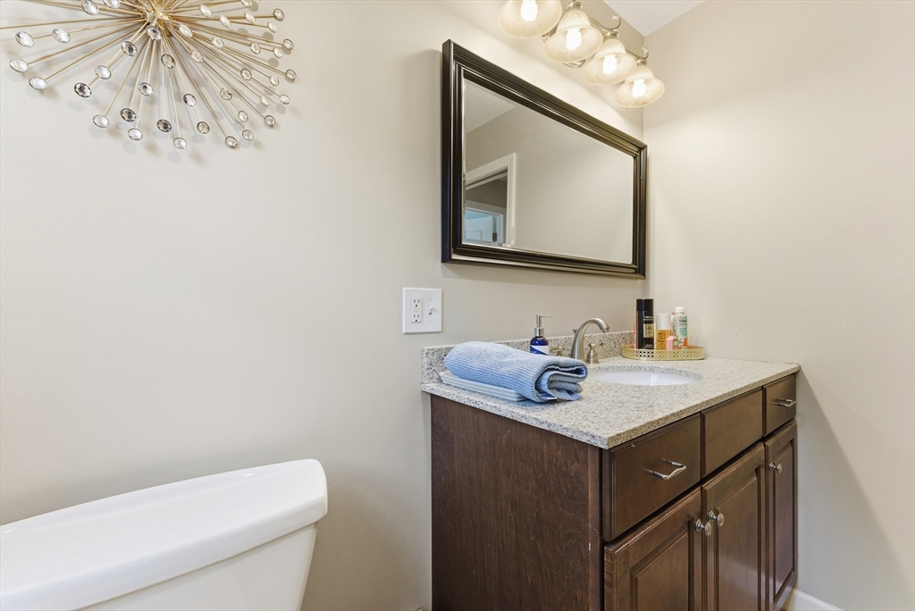 120 Inverness Lane Longmeadow, MA 01106 - Photo 26 of 42 a bathroom with a toilet sink vanity and mirror