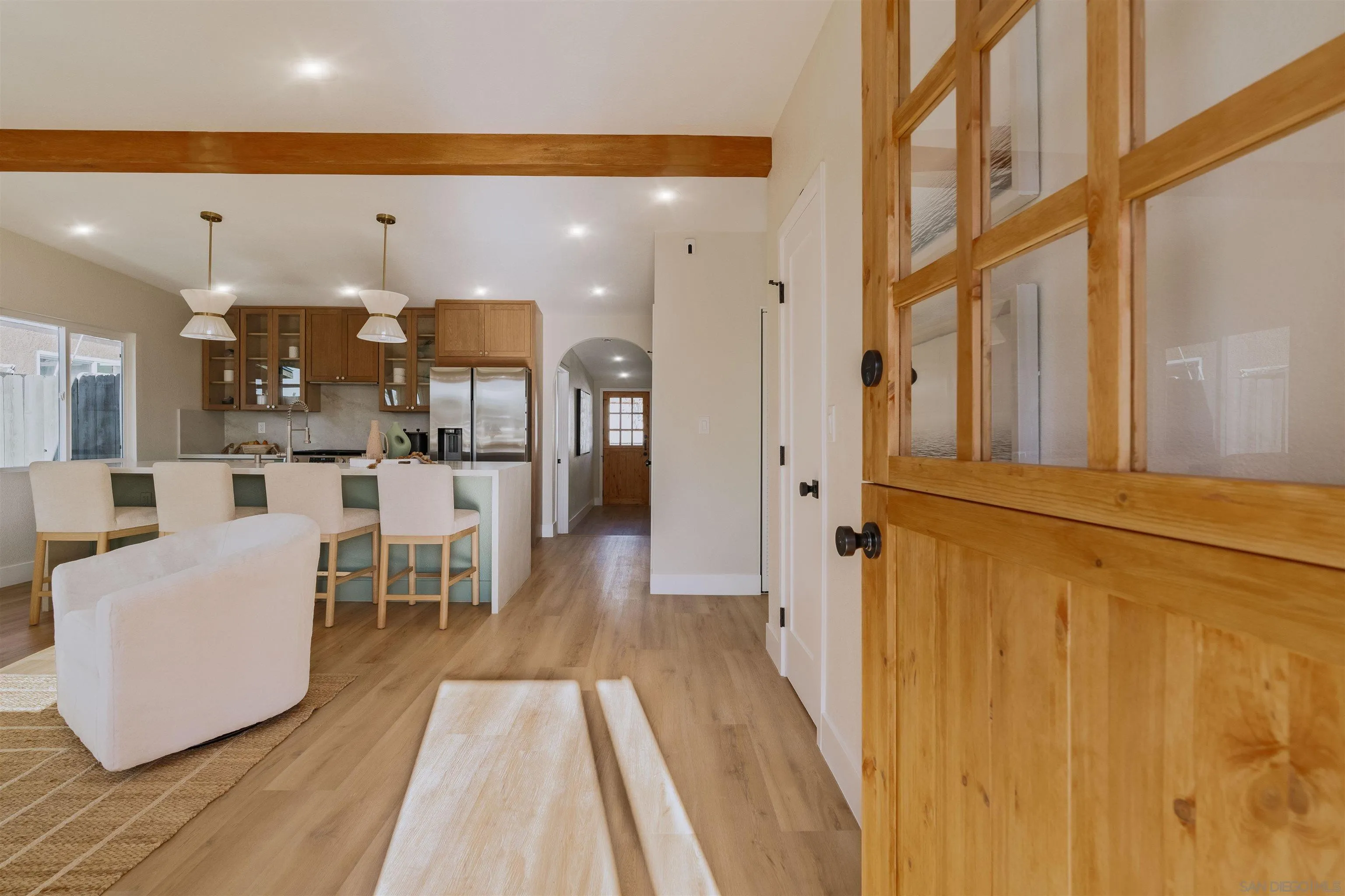 1426 Santa Rosa Street Oceanside, CA 92058 - Photo 12 of 73 a dining hall with stainless steel appliances a dining table wooden floor and a living room view