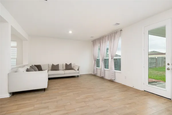 a living room with furniture and large windows