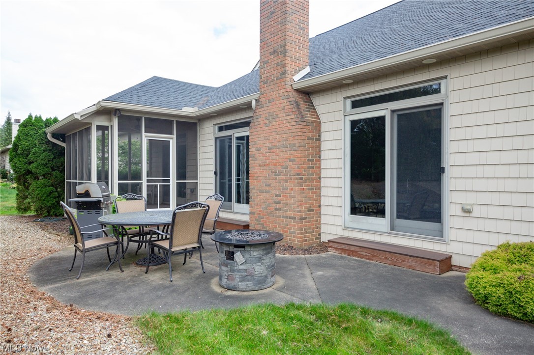3816 Rothrock Place Akron, OH 44333 - Photo 29 of 34 View of patio / terrace with a sunroom and an outdoor fire pit