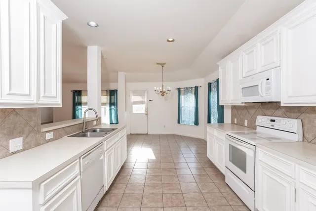 a kitchen with stainless steel appliances a stove sink and cabinets