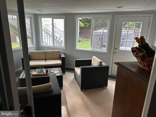 a utility room with dryer washer and a view of living room