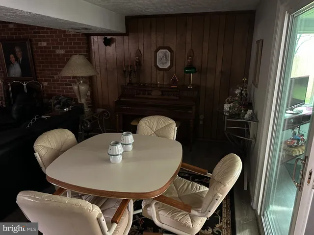 a dining room with furniture and wooden floor