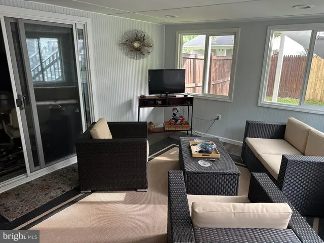a living room with furniture and flat screen tv