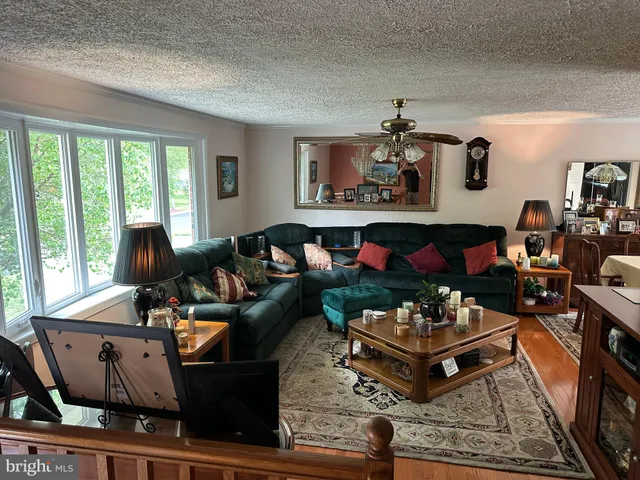 a living room with a flat screen tv and rug