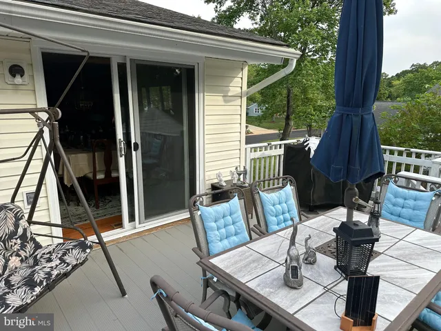 a view of backyard with small cabin and wooden fence
