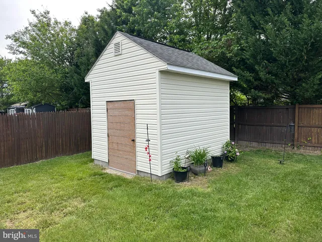 a view of a house with a yard swimming pool and outdoor seating