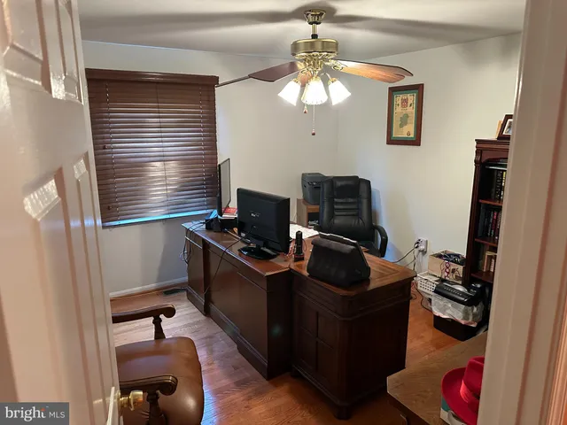 a table with a desk and chair with wooden floor