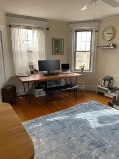 a living room with furniture a chandelier and a pool table