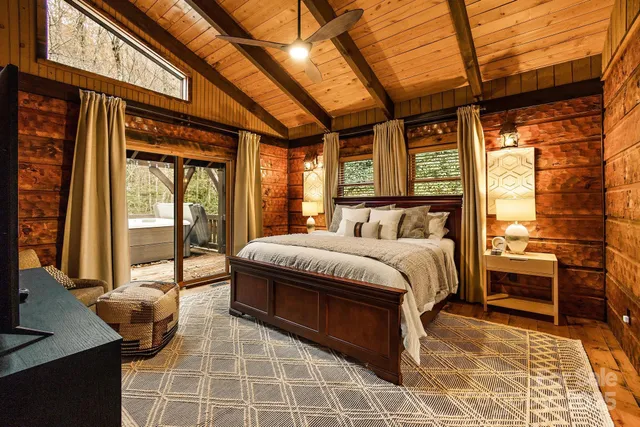 a bedroom with a bed and glass door