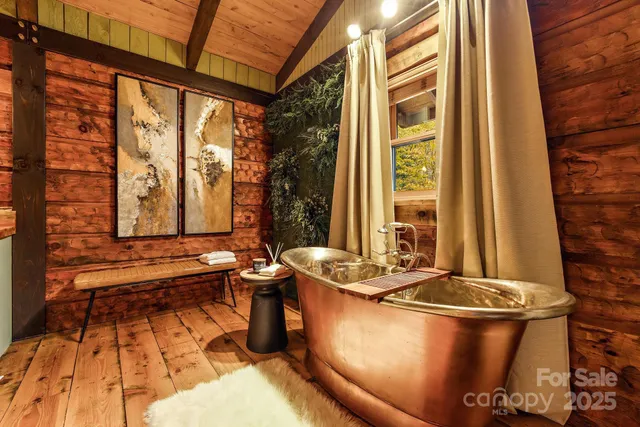 a bathroom with a bathtub and next to a window