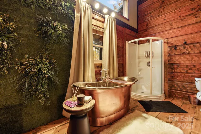 a view of a balcony with a tub and fire pit