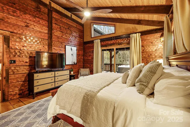 a bedroom with a bed and a flat screen tv