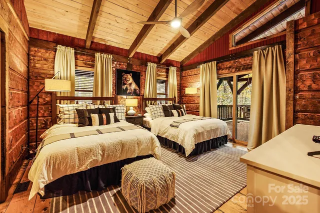 a bedroom with two beds and a large window