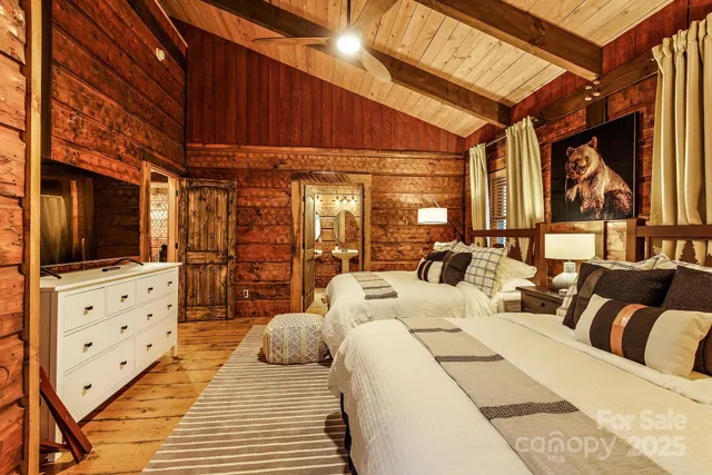 a bedroom with furniture and a flat screen tv