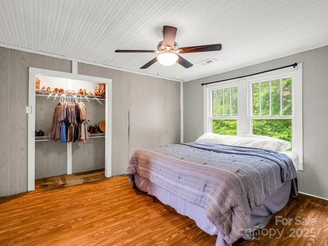 a bedroom with bed and a large mirror