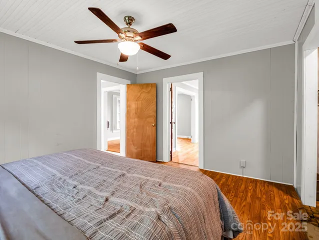 a bedroom with a large bed and a large window
