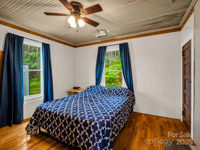 a bed sitting in a bedroom next to a window