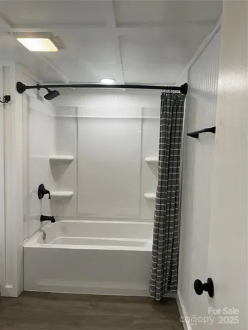 a bathroom with a bathtub and shower