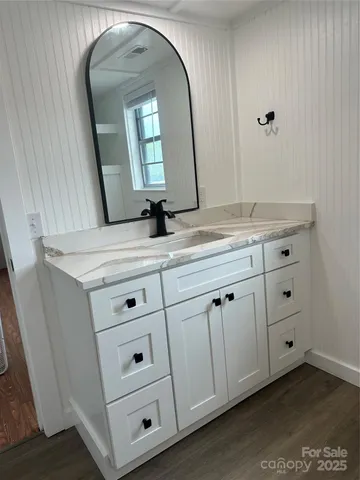 a bathroom with a double vanity sink and mirror